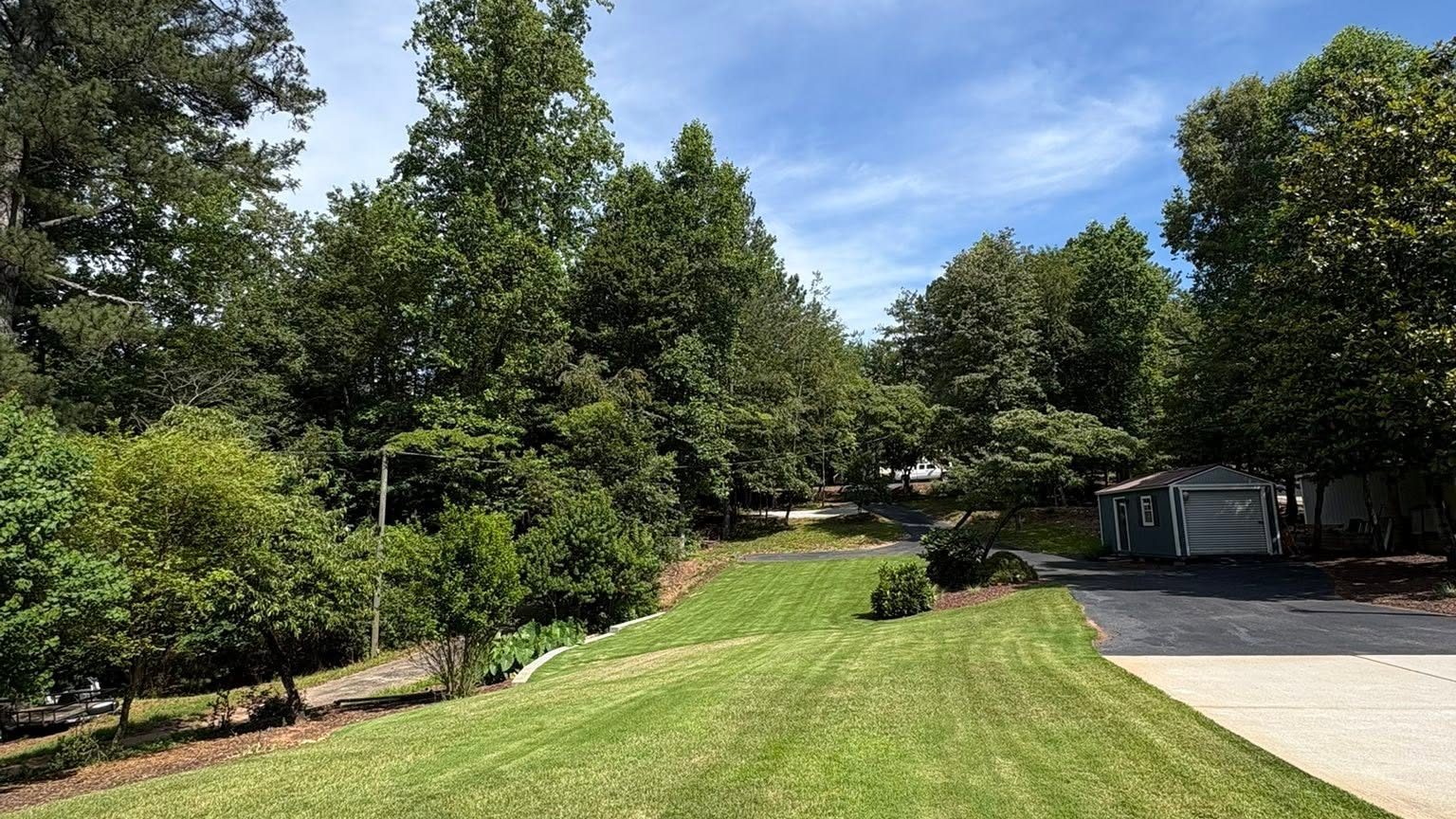 A large, freshly mowed lawn with clean cut lines at a North Lanier property